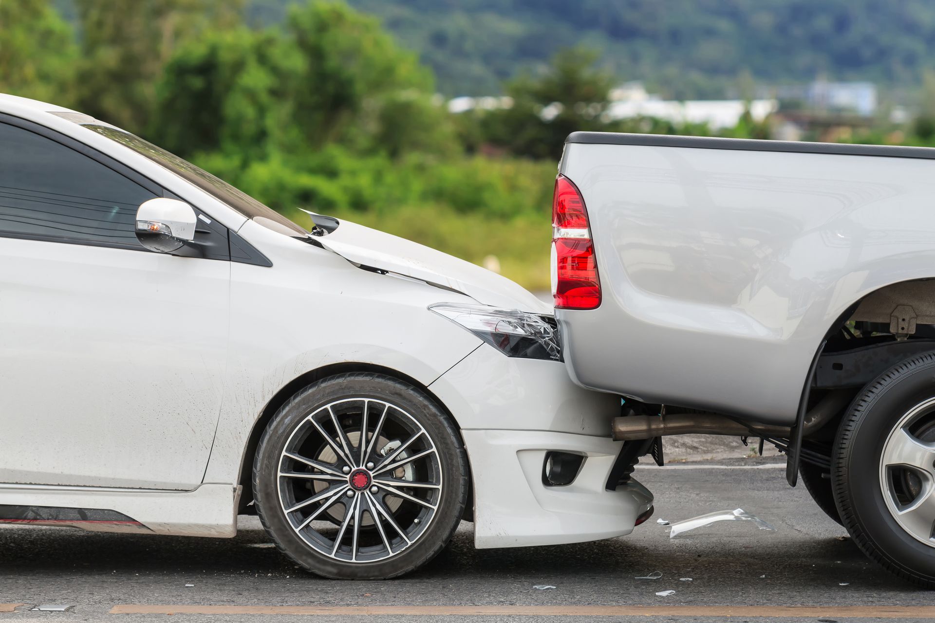 rear end car accident with car front bender crushed under truck 